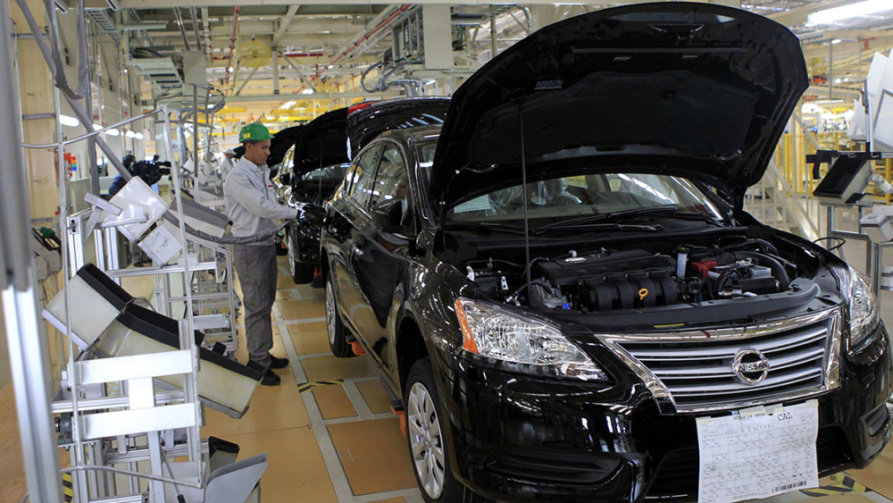 An employee works at a production line before the opening of Nissan's new plant in Aguascalientes - An employee works at a production line before the opening of Nissan's new plant in Aguascalientes, Mexico. November 12, 2013. Japan's Nissan Motor Co Ltd will be producing 1 million cars in Mexico by 2016, cementing Mexico's position as export hub for Nissan in the Americas, Chief Executive Carlos Ghosn told Reuters on Tuesday as he inaugurated the $2 billion plant.  REUTERS/Henry Romero (MEXICO - Tags: TRANSPORT BUSINESS EMPLOYMENT)