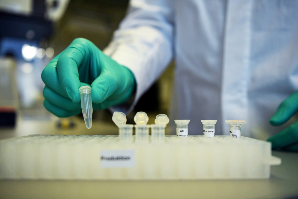 FILE PHOTO: FILE PHOTO: Employee Philipp Hoffmann, of German biopharmaceutical company CureVac, demonstrates research workflow on a vaccine for the coronavirus (COVID-19) disease at a laboratory in Tuebingen