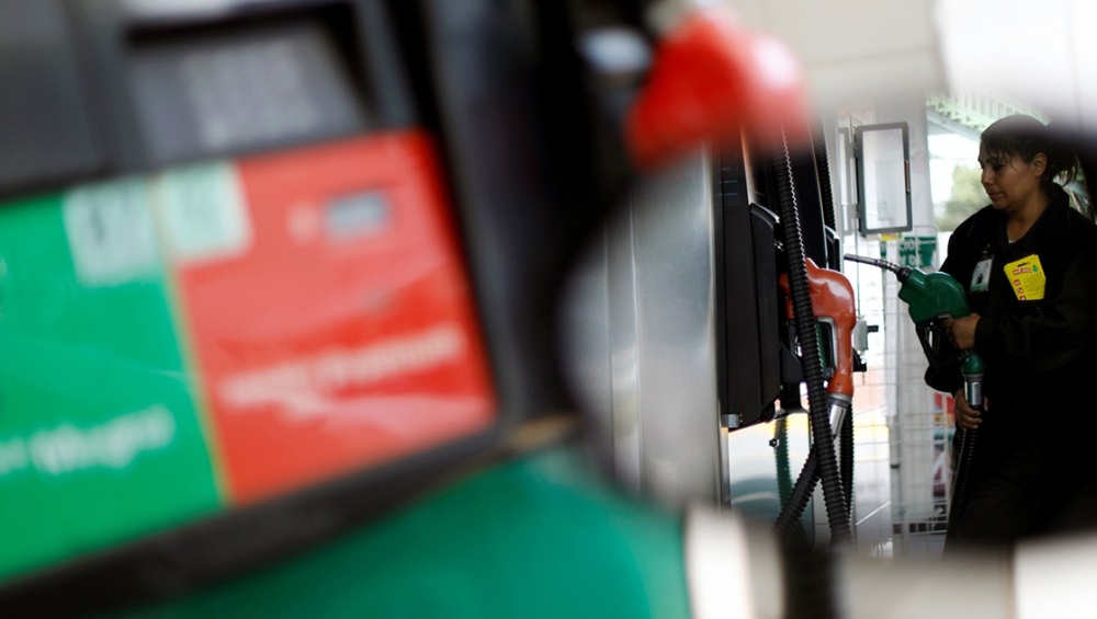 An employee holds the nozzle of a fuel pump at a Pemex gas station in Mexico City, Mexico February 8, 2018. REUTERS/Edgard Garrido