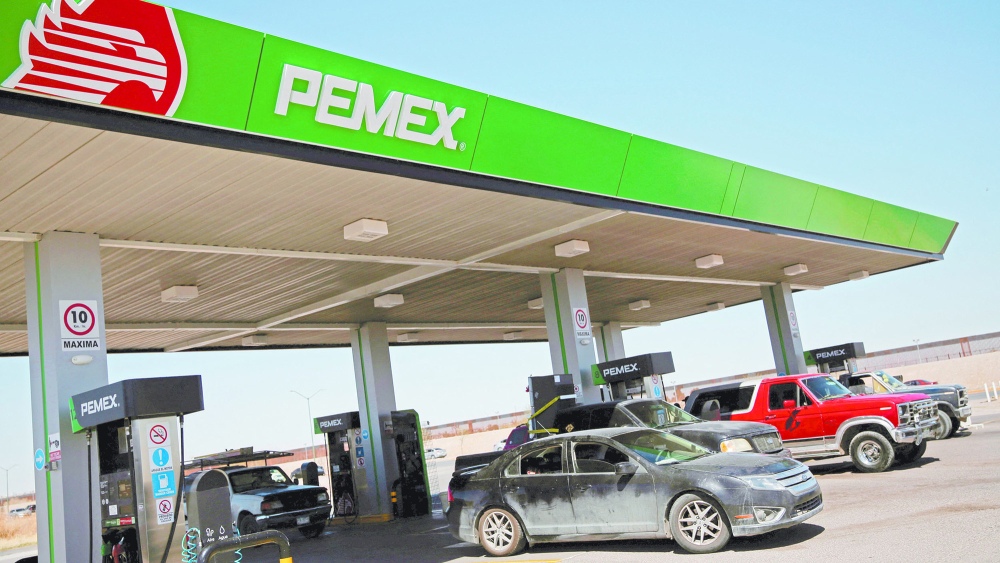 Vehicles are seen next to fuel pumps at company Petroleos Mexicanos (PEMEX) in a service station after Mexico suspended a week of gasoline subsidy along the U.S. border, in Ciudad Juarez