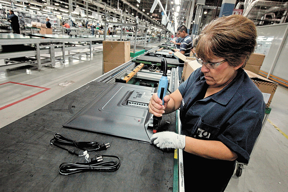 FILE PHOTO: An employee works at an LED TV assembly line at a factory that exports to the U.S. in Ciudad Juarez