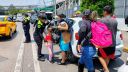 Elementos de seguridad apoyan a usuarios del AICM a acceder a las terminales del aeropuerto ante los bloqueos realizados por manifestantes de la CNTE.