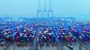 FILE PHOTO - Containers and trucks are seen on a snowy day at an automated container terminal in Qingdao port