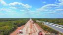 Workers and equipment are seen at the construction site of section 4 of the new Mayan Train route in Valladolid, Yucatan, Mexico, February 26, 2022.  In the eyes of President Andres Manuel Lopez Obrador, the railway his government is building - known as the Tren Maya - will bring modern connectivity to areas for generations deprived of significant economic benefits. But pristine wilderness and ancient cave systems beneath the jungle floor are critically endangered by the railway and its hasty construction, droves of scientists and environmental activists say.  REUTERS/Raquel Cunha     SEARCH