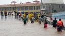 People walk on a flooded street heading to a shelter following Hurricane John in Acapulco, Guerrero State, Mexico, on September 27, 2024. Mexican troops scrambled Friday to help victims of a hurricane that battered the Pacific coast, including the beach resort of Acapulco, which is still recovering from a devastating storm last year. (Photo by Francisco ROBLES / AFP)