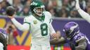 Oct 6, 2024; London, United Kingdom; New York Jets quarterback Aaron Rodgers (8) throws the ball under pressure from Minnesota Vikings center Garrett Bradbury (56) in the second half at Tottenham Hotspur Stadium. Mandatory Credit: Kirby Lee-Imagn Images