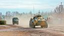 Military vehicles drive along a street, after Russian President Vladimir Putin authorized a military operation in eastern Ukraine, in the town of Armyansk, Crimea, February 24, 2022. REUTERS/Stringer