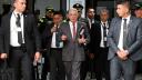 Colombian former President Alvaro Uribe (C) gestures as he leaves a court complex at the end of his trial in Bogota on February 10, 2025. The oral trial against former Colombian president Alvaro Uribe for procedural fraud and witness tampering began on February 6, 2025, despite requests from the defense to postpone what is the last stage in the historic criminal trial before the verdict. (Photo by Raul ARBOLEDA / AFP)