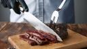 Hands in black gloves slice medium rare cooked whale meat steak with knife and fork