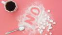 Word No made of sugar and cup of coffee on pink background, flat lay, diabetes problems, harm from eating, dependence on flavoring.