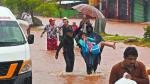 People walk on a flooded street after the hit of Hurricane John in Acapulco, Mexico, on September 26, 2024. - Hurricane John, which made landfall in Mexico on September 23, leaving at least five dead, re-formed as a cyclone early September 26, and is expected to hit the country again, authorities said. (Photo by Francisco Robles / AFP)