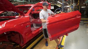 FILE PHOTO: A Ford Motor assembly worker works on a Ford Mustang vehicle at the Ford Motor Flat Rock Assembly Plant in Flat Rock, Michigan