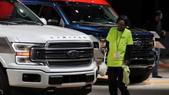FILE PHOTO: FILE PHOTO: A worker cleans Ford pickup truck at the North American International Auto Show in Detroit, Michigan