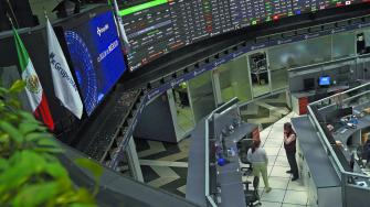 Employees interact as a ticker displays stock exchange data at Mexico's stock exchange, in Mexico City, Mexico June 1, 2021. REUTERS/Toya Sardo Jordan