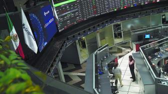 Employees interact as a ticker displays stock exchange data at Mexico's stock exchange, in Mexico City, Mexico June 1, 2021. REUTERS/Toya Sardo Jordan