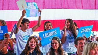 Latino attendees dance before a rally held by Democratic presidential nominee and U.S. Vice President Kamala Harris, at Coastal Credit Union Music Park at Walnut Creek, in Raleigh, North Carolina, U.S., October 30, 2024. REUTERS/Sam Wolfe