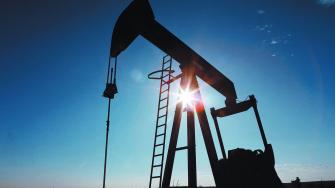 FILE PHOTO: The sun is seen behind a crude oil pump jack in the Permian Basin in Loving County, Texas, U.S., November 22, 2019. Picture taken November 22, 2019.  REUTERS/Angus Mordant/File Photo