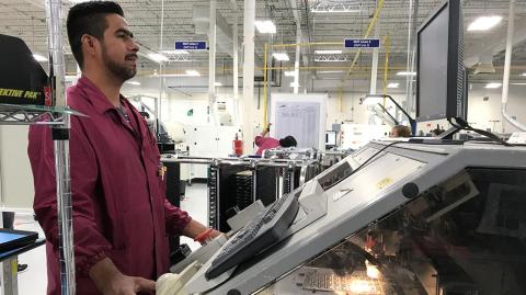 A worker checks his monitor at Firstronicâ€™s Juarez plant assemble electronic parts for cars built by GM Audi and Hyundai among others in Ciudad Juarez