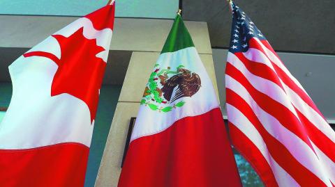 (FILES) This file photo taken on September 24, 2017 shows the Mexican, US and  Canadian flags in the lobby where the third round of the NAFTA renegotiations took place in Ottawa, Ontario.
Canada announced on January 23, 2018 it will sign on the Trans Pacific Partnership, moving to diversify its trade relationships  as Canadian, US and Mexican negotiators kicked off a sixth round of talks on a 1994 free trade pact that Washington has threatened to dump. Canada had initially balked at joining the proposed TPP last year, acting as the main holdout in negotiations after US President Donald Trump decided in early 2017 to go it alone under his "America First" policy.
 / AFP PHOTO / Lars Hagberg