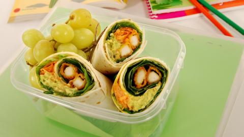 School lunch of fried chicken & avocado wrap sandwich