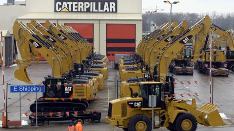 File photo of workers walk past Caterpillar excavator machines at a factory in Gosselies - Workers walk past Caterpillar excavator machines at a factory in Gosselies in this February 28, 2013, file photo. Caterpillar Inc cut its full-year outlook for 2013 on April 22, 2013, to reflect a drop in demand for heavy equipment from its mining customers. REUTERS/Eric Vidal/Files   (BELGIUM - Tags: BUSINESS CONSTRUCTION EMPLOYMENT)