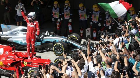 Ferrari driver Sebastian Vettel, of Germany, celebrates after winning the Brazilian Formula One Grand Prix at the Interlagos race track in Sao Paulo, Brazil, Sunday, Nov. 12, 2017. (AP Photo/Andre Penner)