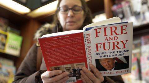 Kathy Mallin - CORRECTS FIRST NAME TO KATHY, NOT SUSAN - Kathy Mallin, from Glenview, Ill., looks over a copy of the book "Fire and Fury: Inside the Trump White House" by Michael Wolff at Barbara