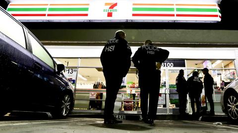 U.S. Immigration and Customs Enforcement agents serve an employment audit notice at a 7-Eleven convenience store Wednesday, Jan. 10, 2018, in Los Angeles. Agents said they targeted about 100 7-Eleven stores nationwide Wednesday to open employment audits and interview workers. (AP Photo/Chris Carlson)