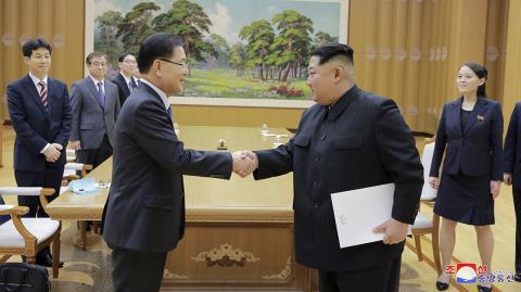 North Korean leader Kim Jong Un shakes hands with Chung Eui-yong in this photo released by North Korea