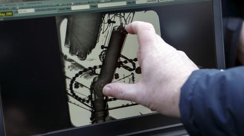 A UCI technician shows the detection of an engine in the frame of a bicycle scaned by a X-Ray machine, during a UCI