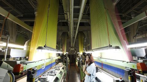 A worker stands by looms at the Veba textile factory in Broumov, Czech Republic, Tuesday, Sept. 25, 2012. When the managers of a textile factory in northern Czech Republic declared they would focus sales on Africa, their bankers, insurers and suppliers shook their heads in disbelief. A decade later, the decision is paying off. While the textile industry in Europe is under pressure from low-cost competition in Asia, the Czech company Veba is working around the clock to meet demand for the high-quality brocade it ships to Muslims and elites in western Africa. The textiles are of a better quality than those shipped in from China and have become a favorite among Africa’s Mecca-bound pilgrims. (AP Photo/Petr David Josek)