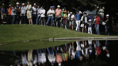 Spectators watch across a lake at the 6th hole, during round one of the Mexico Championship at Chapultepec Golf Club in Mexico City, Thursday, March 2, 2017. All but one of the world