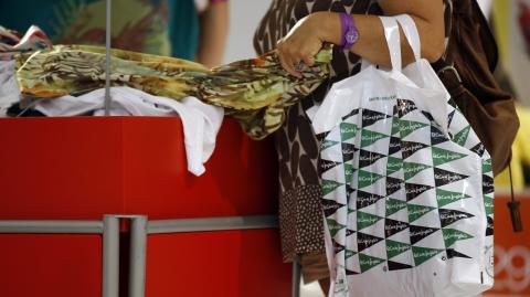 A customer searches for clothes inside an El Corte Ingles department store in Madrid