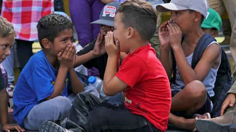 Migrant kids chant "We want to study" as they block the Puerta Mexico international border crossing bridge in Matamoros