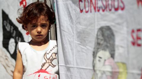 An Iraqi Yazidi refugee girl attends a commemoration of the third anniversary of the Yazidi genocide in Sinjar region, in the village of Nea Apollonia