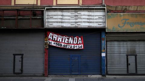 A closed store with a sign that reads "Rented by owner" in a commercial sector of Santiago, during a preventive quarantine after the outbreak of coronavirus disease (COVID-19), in Santiago