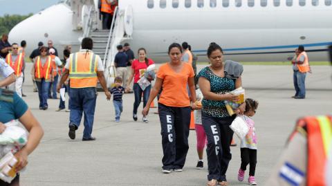 Handout photo of women and children at the Ramon Villeda international airport in San Pedro Sula after deportation from U.S.