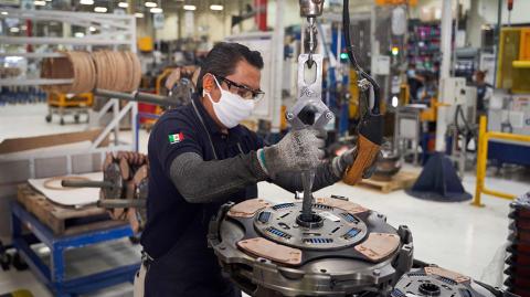 A worker resumes activities at a truck part factory after it was closed for several weeks to prevent the spread of coronavirus in San Luis Potosi, Mexico on May 27, 2020. (Photo by MAURICIO PALOS / AFP)