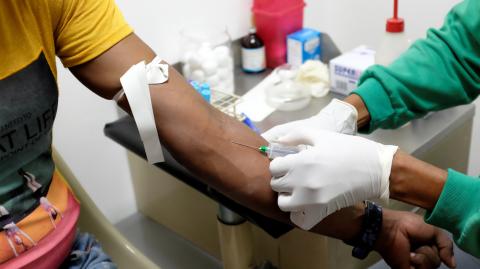 A nurse draws a blood sample for an HIV test at the lab of the NGO "Accion Solidaria" in Caracas