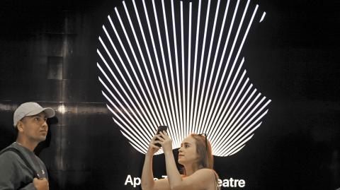 Customers walk around the new Apple Store on Broadway in downtown Los Angeles