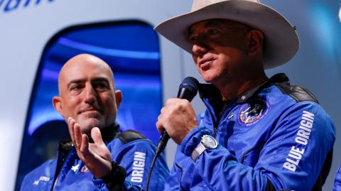 FILE PHOTO: Billionaire American businessman Jeff Bezos speaks with his brother Mark at a post-launch press conference, in the nearby town of Van Horn