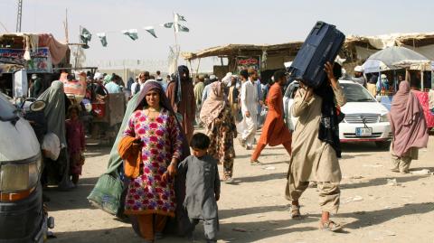 People cross Friendship Gate at the Pakistan-Afghanistan border town of Chaman