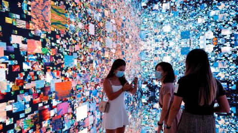 FILE PHOTO: Visitors are pictured in front of an art installation which will be converted into NFT and auctioned online at Sotheby