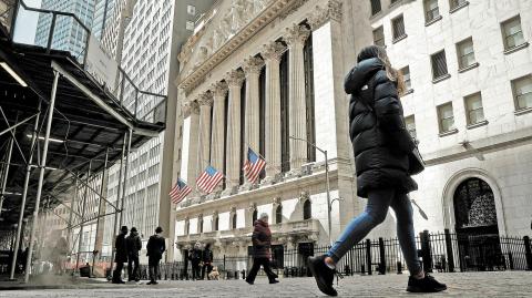 FILE PHOTO: People are seen on Wall Street outside the New York Stock Exchange (NYSE) in New York City, U.S., March 19, 2021.  REUTERS/Brendan McDermid/File Photo-NARCH/NARCH30 NARCH/NARCH30