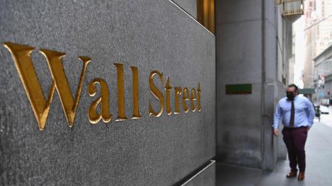 A man walks near the New York Stock Exchange (NYSE) on August 31, 2020 at Wall Street in New York City. - Wall Street stocks paused near record levels early Monday ahead of key economic data later in the week, with a newly-tweaked Dow index edging lower. The final session of a heady August opened on a lackluster note as markets await employment data and updates on the manufacturing and services sectors in the coming days. About 15 minutes into trading, the Dow Jones Industrial Average was down 0.4 percent to 28,539.83. (Photo by Angela Weiss / AFP)