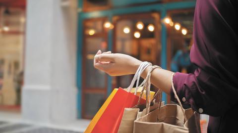 woman with shopping bags at outdoor market mall