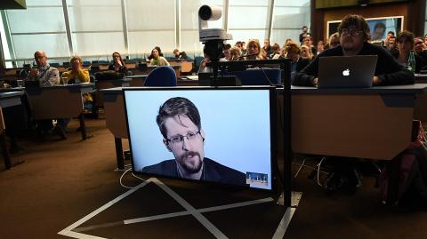 (FILES) In this file photo taken on March 15, 2019 former US National Security Agency (NSA) contractor and whistle blower Edward Snowden speaks via video link from Russia as he takes part in a round table meeting on the subject of