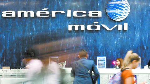 FILE PHOTO: The logo of America Movil is pictured on the wall of a reception area in the company's corporate offices in Mexico City, Mexico, May 18, 2017. REUTERS/Edgard Garrido/File Photo-NARCH/NARCH30