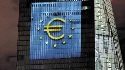 FILE PHOTO: A symphony of light consisting of bars, lines and circles in blue and yellow, the colours of the European Union, illuminates the south facade of the European Central Bank (ECB) headquarters in Frankfurt, Germany, December 30, 2021.   REUTERS/Wolfgang Rattay/File Photo-NARCH/NARCH30