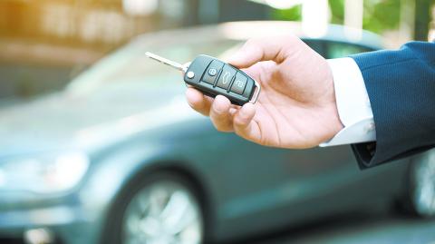 Dreams Come True. Young man holds the keys to a new car